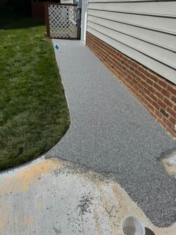 Cracked and stained concrete driveway before resurfacing
