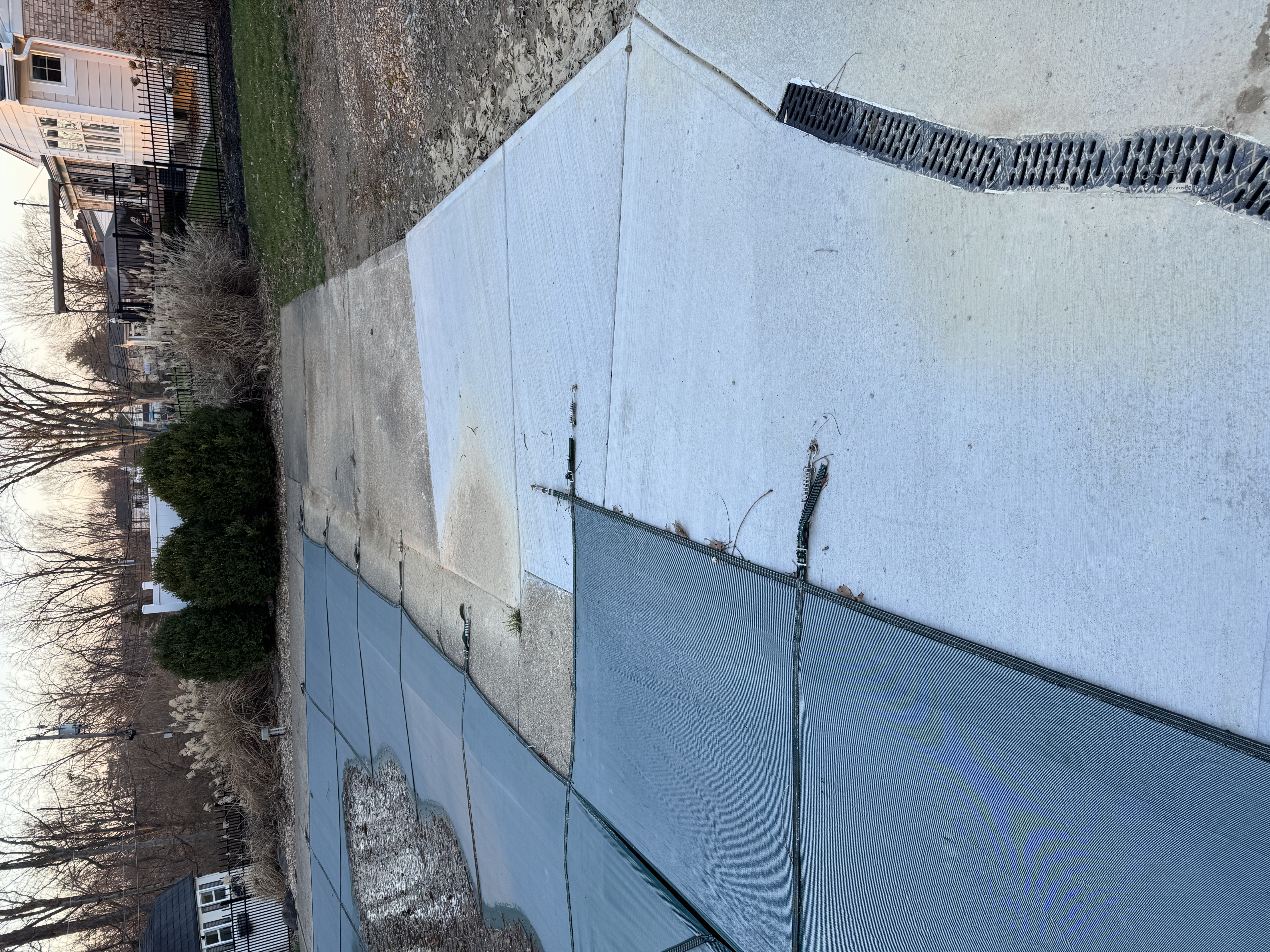Sharonville pool deck before resurfacing—covered pool and weathered concrete beside new deck pour
